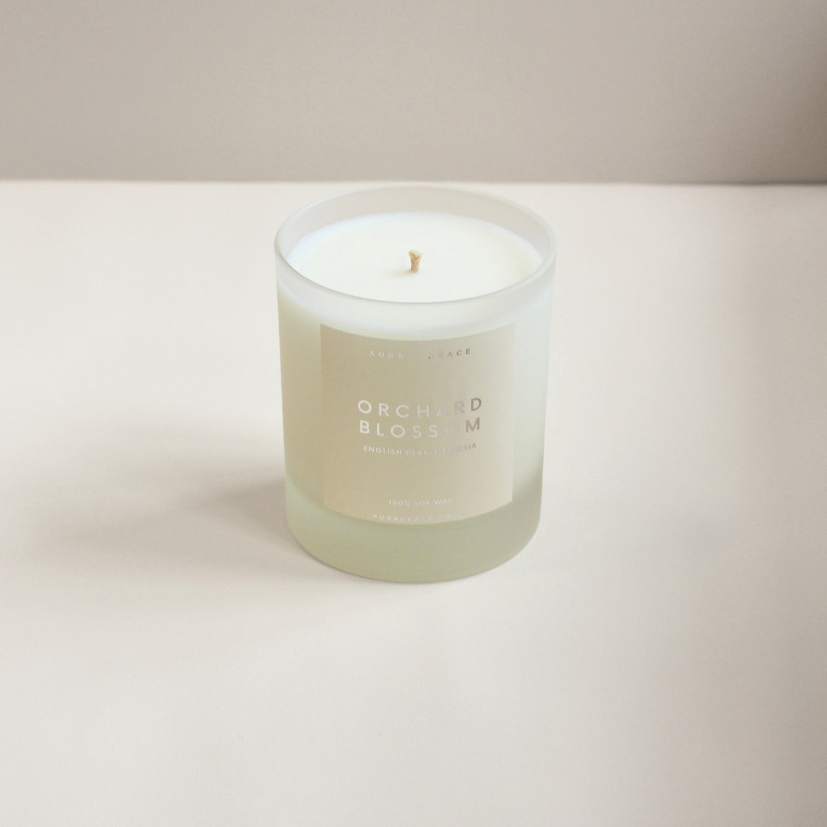 Hand-poured Orchard Blossom soy candle with English pear and freesia fragrance