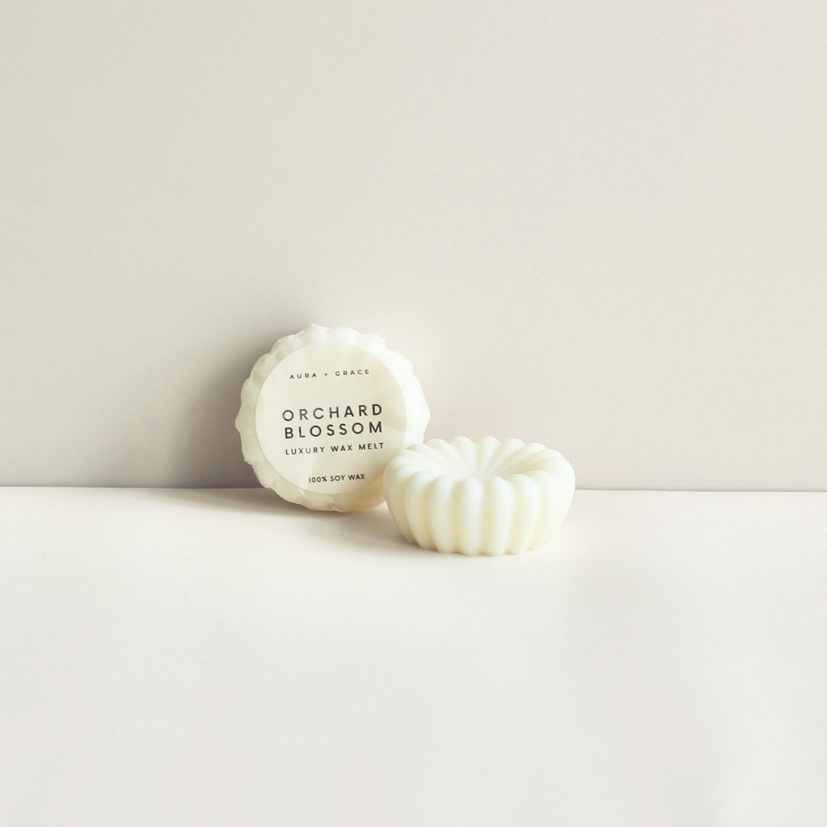 Orchard Blossom soy wax melts showing wrapped and unwrapped melt by Aura + Grace